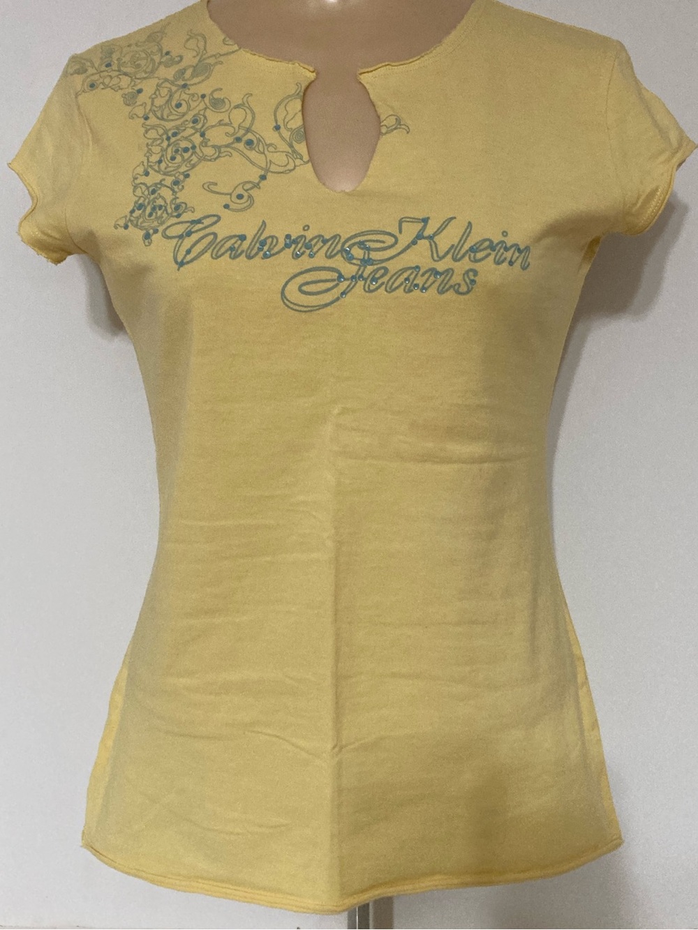Vintage C.K Jeans Yellow Script Tee w/blue Sequined Scroll. Item# SSct34